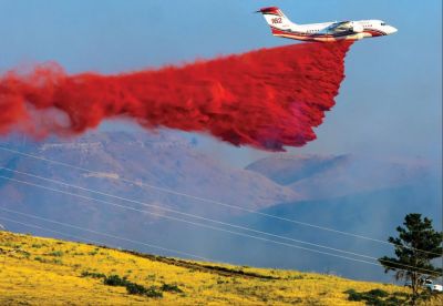 A BAE-146 air tanker, capable of carrying 3,000 gallons of retardant, drops its payload during the Aristocrat Fire south of campus, Friday. (FIRST PLACE, Best Breaking News Photo, Non-daily Division, circ. less than 5,000 | Brandon Davenport, The Eagle, Chadron, Nebraska)