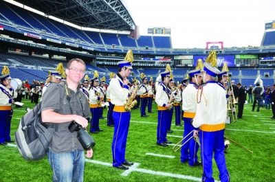 Sequim Gazette Editor Michael Dashiell covers the Sequim High School band’s participation at Husky Band Day in Seattle in 2016.  (Photo by Patsene Dashiell)