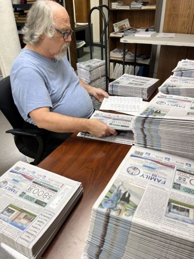 Dennis Fair applies subscribers  mailing labels to hundreds of newspapers. Each Wednesday, three labelers address nearly about 6,500 copies of the newspaper. Fair is one of several Beaconites who work fewer than 10 hours a week.