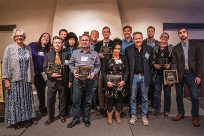The Taos News team celebrates winning the New Mexico Press Association s General Excellence Award for large weeklies. The newspaper plans to use New Mexico News Fund Accelerator money to launch a podcast. Publisher Chris Baker is pictured on the front row, third from right. (The Taos News)