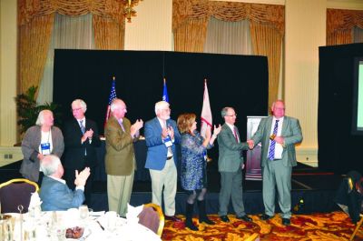 During the 133rd Annual Convention & Trade Show in Milwaukee, Wisconsin, NNA past presidents pass the gavel — L to R: Diane Everson, publisher of The Edgerton  (Wisconsin) Reporter (2000); Reed Anfinson, publisher of the Swift County Monitor-News in Benson, Minnesota (2011); Robert M. Williams, retired publisher of the Blackshear (Georgia) Times (2013); Matt Paxton, publisher of The News-Gazette in Lexington, Virginia (2016); Susan Rowell, publisher of The Lancaster (South Carolina) News (2017); Andrew Johnson, retired publisher of The Dodge County Pionier in Mayville, Wisconsin (2018); and Matt Adelman, publisher of the Douglas (Wyoming) Budget (2019).