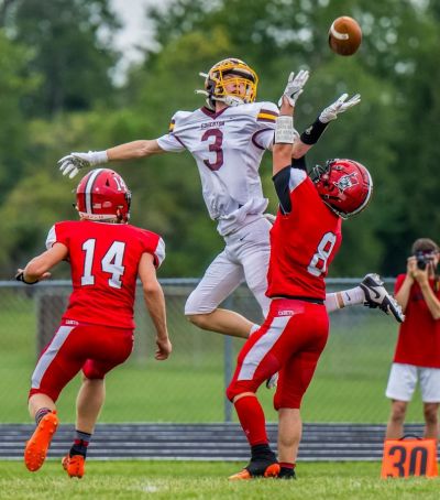 ACROBATIC CATCH - Edgerton wide receiver Scottie Krontz goes up to catch a pass over the top of two Hilltop defensive backs. (Date of publication: August 30, 2023) (Rich Harding, The Village Reporter, Montpelier, Ohio)